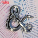 Dungeons and Dragons metal medallion,D&D ampersand medallion,Dungeons and Dragons gift for Dungeon Master,DnD collector's gift UK,official D&D merchandise UK,Dungeon Master gift ideas,D&D limited edition collectible,DnD metal medallion,Dungeons and Dragons jewellery,tabletop gaming gifts UK,D&D memorabilia UK,official Dungeons and Dragons merch