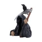 Grim reaper with raven figurine