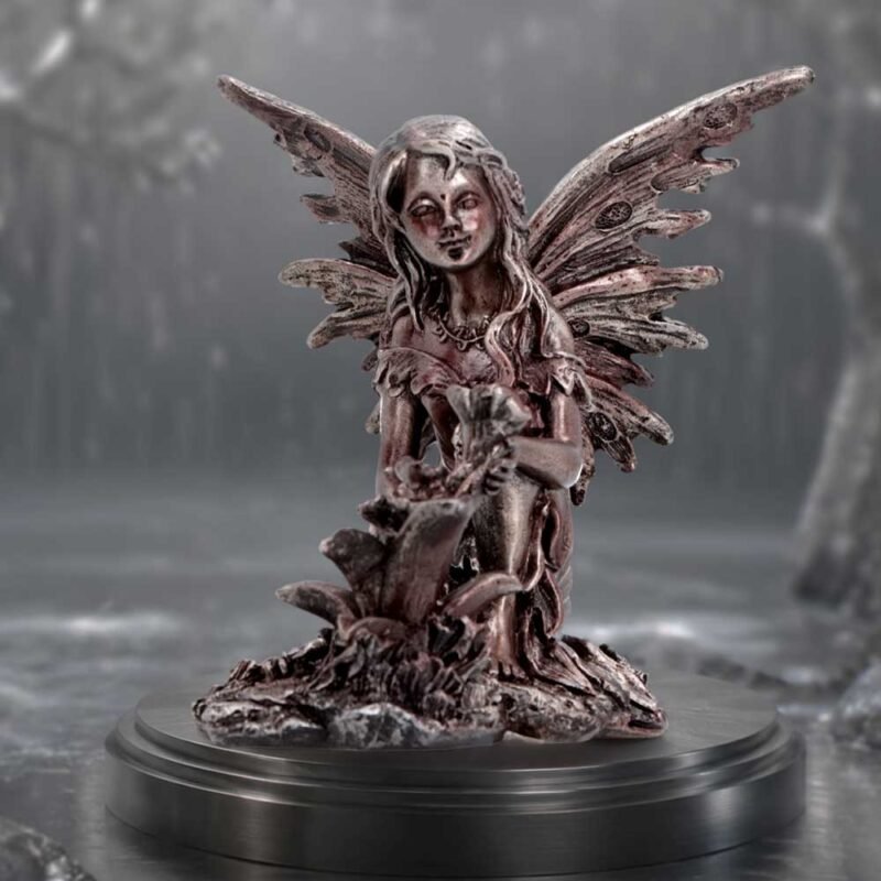 Fairy figurine holding flowers.