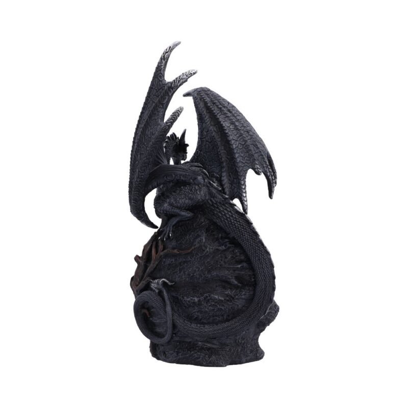 Black dragon statue perched on rock.